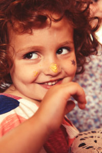 Party Girl nibbles from a cupcake, has cupcake cream on ter nose Party Girl nibbles from a cupcake, has cupcake cream on ter nose
